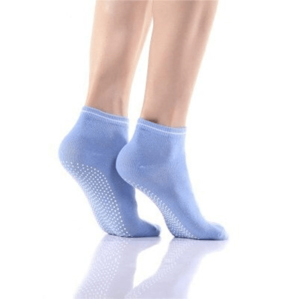 Light blue sports anti-slip breathable women's socks with massage granules, shown on feet, highlighting comfort and non-slip grip.